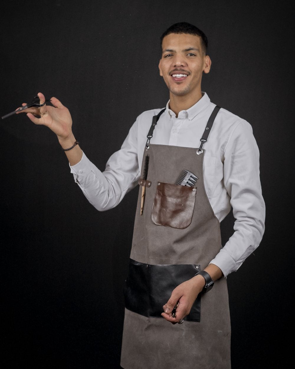 Portrait of Diego, a barber holding his scissors