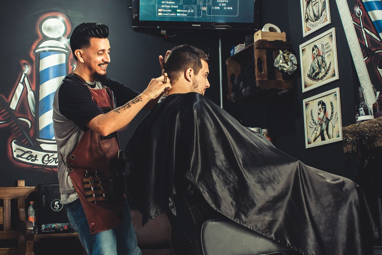 A Fadehouse barber blending a fade for a client in the chair