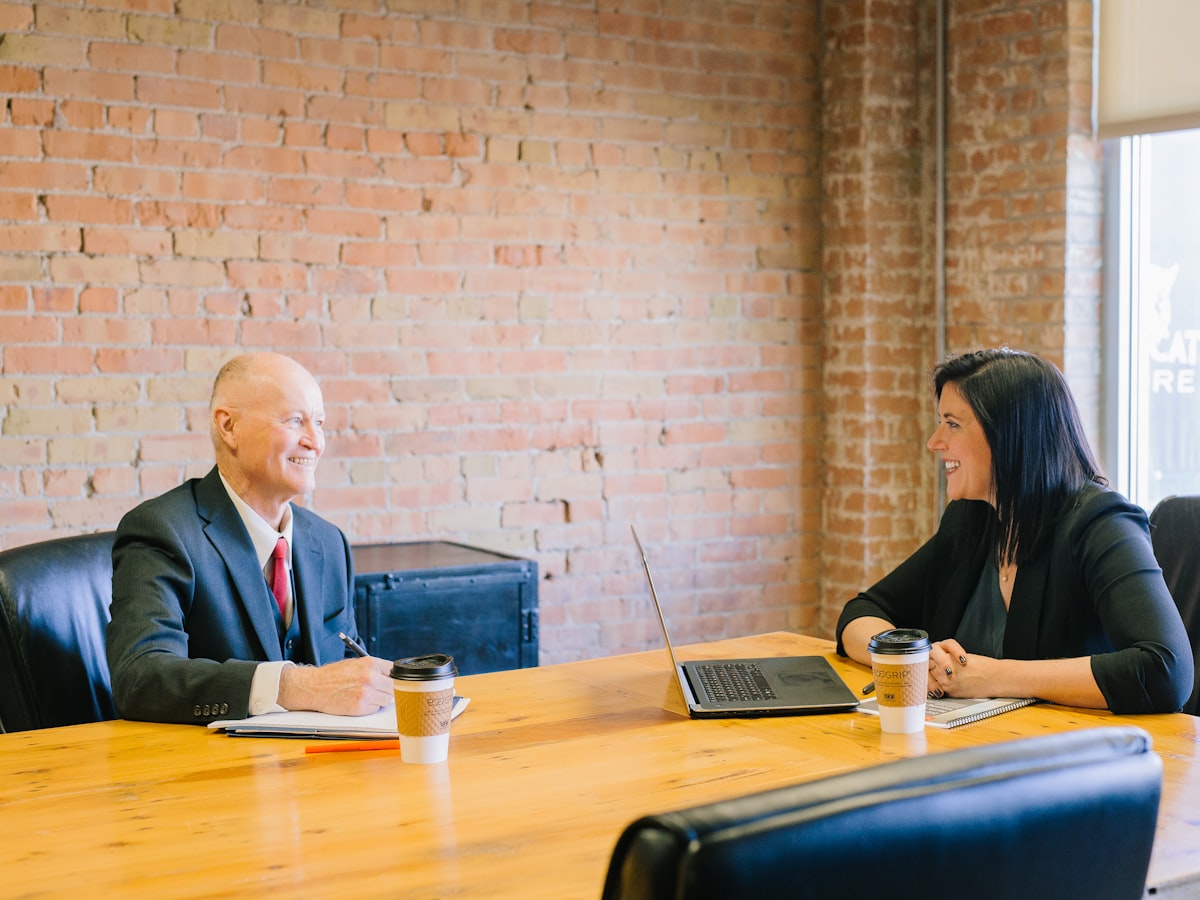 An attorney meeting with a client across the table