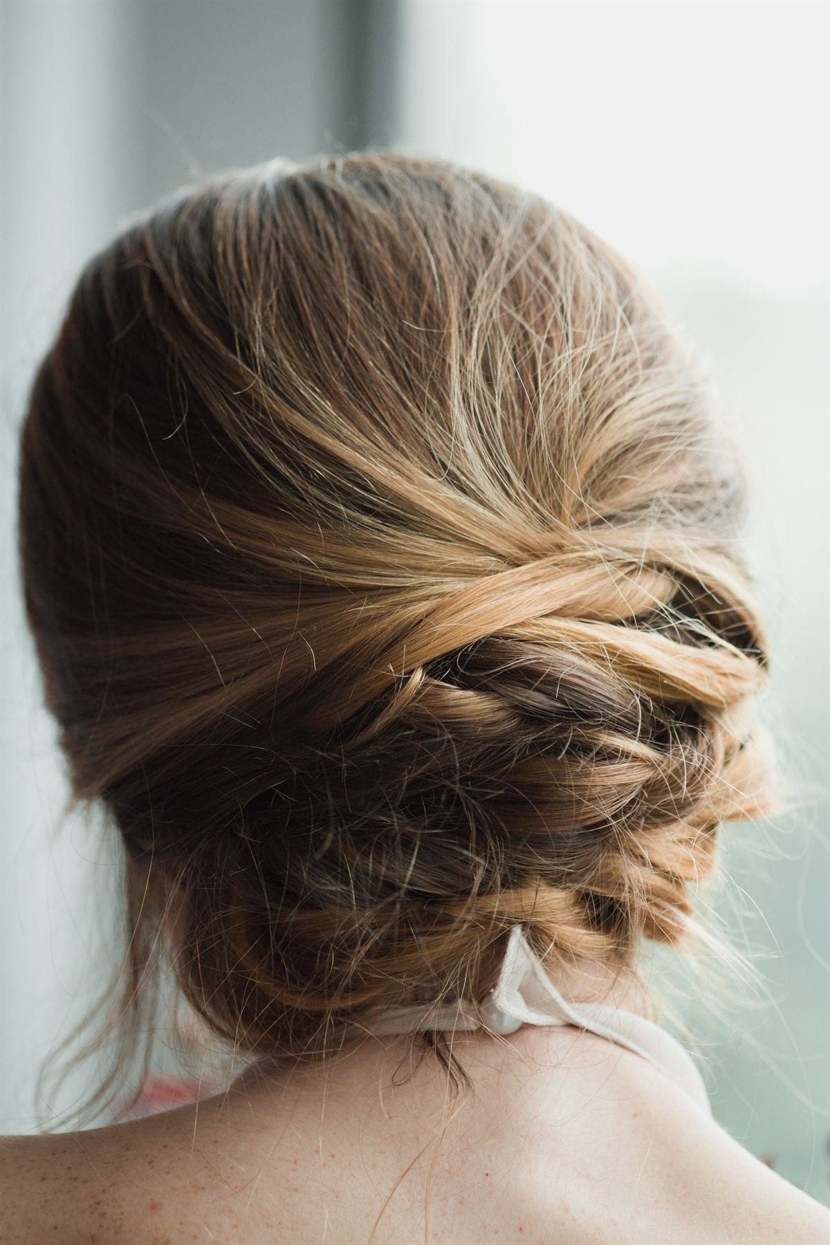 A soft twisted chignon updo seen from behind